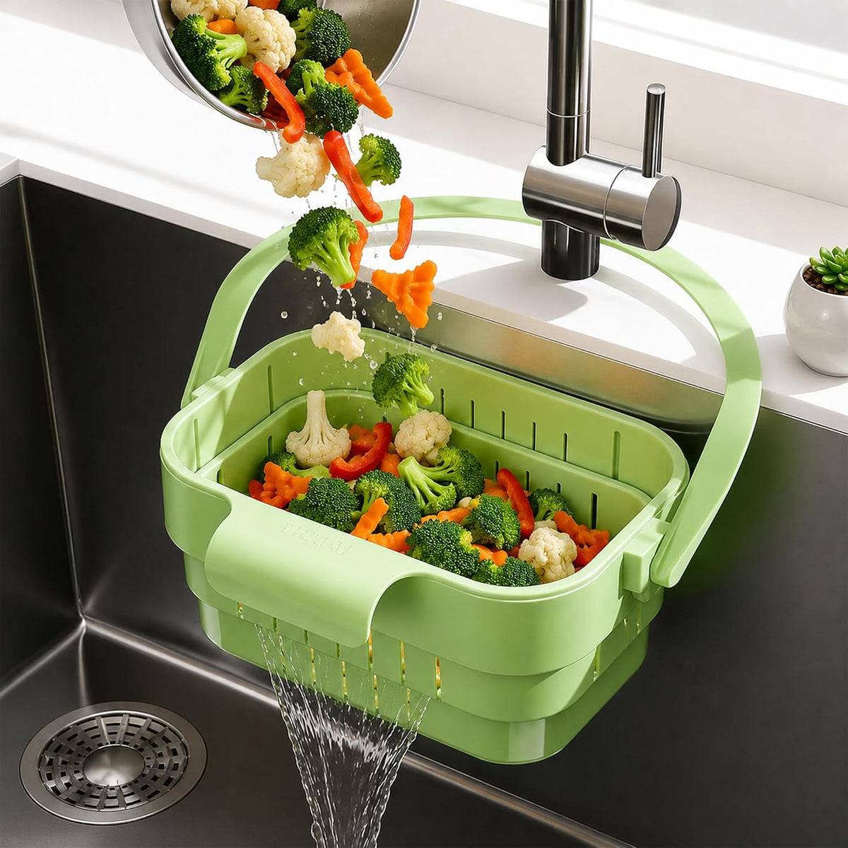 Original green hanging sink drain basket holding freshly washed broccoli carrots and cauliflower with water draining into the sink